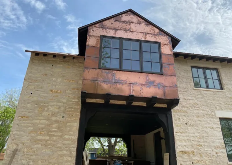 Copper metal panel facade on a stone building for Skylight Installation in Sartell